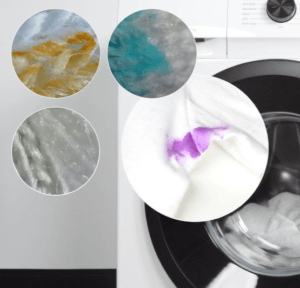 Close-up of a washing machine with a white garment stained by purple, yellow, blue, and gray marks, each shown in