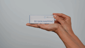 A person holds a rectangular white box labeled 3D SKIN MAPPING TOOL with UPSOLUTIONS and a blue logo above it against a