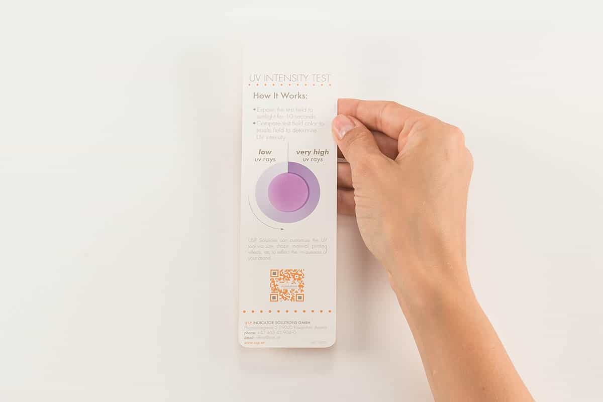 Hand holds UV Intensity Test for UV Brands | USP Solutions