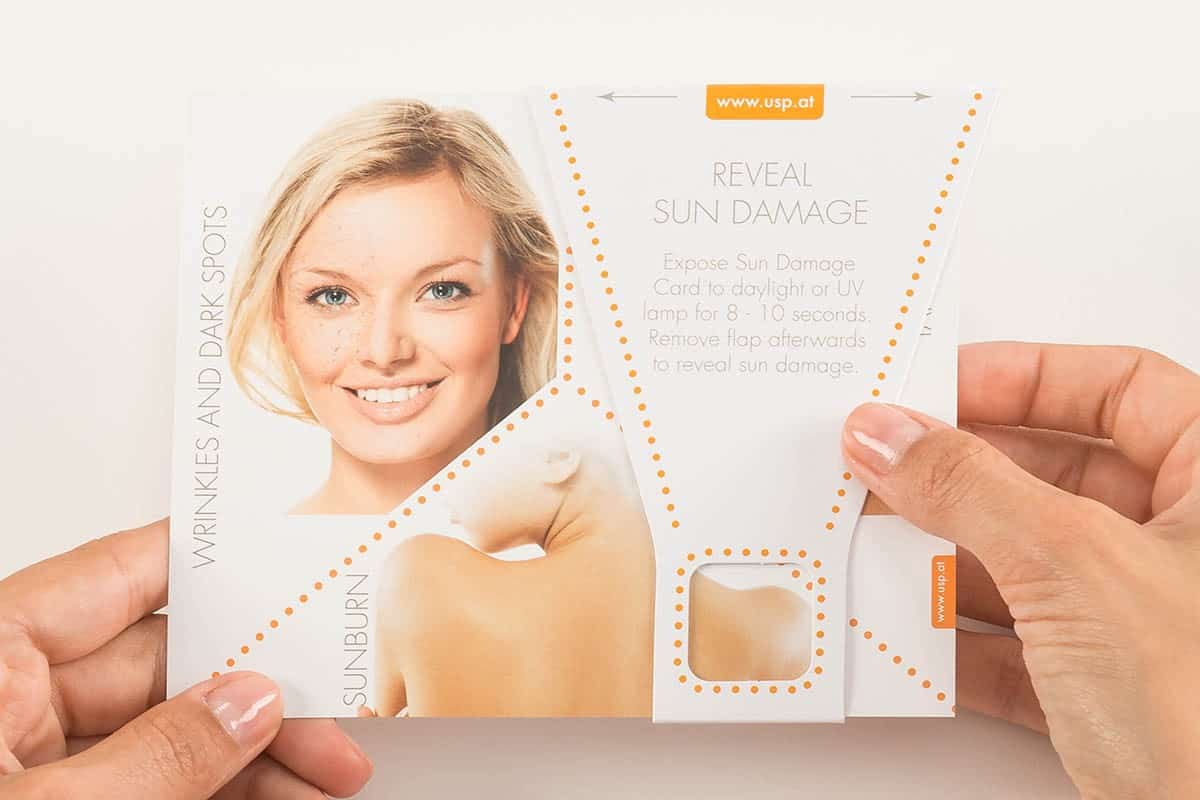 Hand holds Reveal Sun Damage Tool| USP Solutions